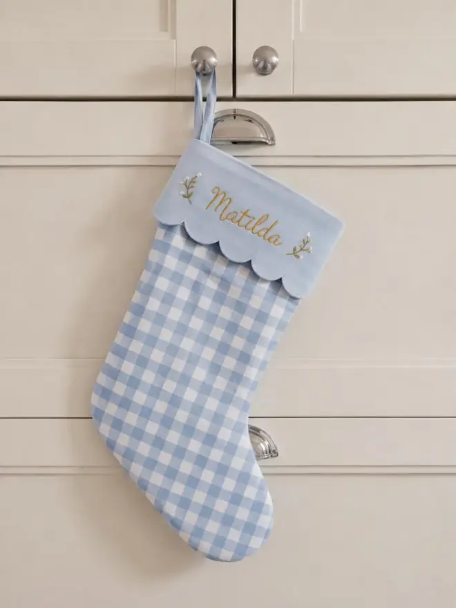 pale blue stocking with scalloped top and personalised embroidery