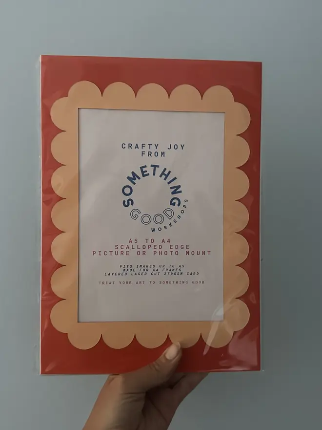 Scallop Edged A5 / A4 photo mount. red and orange variant held against grey background.