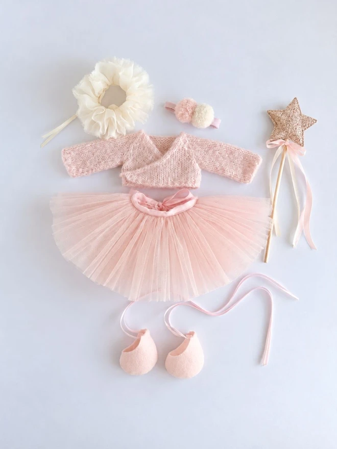 Flat lay of the Verity Isabelle ballerina bunny outfit with pink tutu, knitted cardigan, ruffle collar, headband, ballet shoes and star wand.