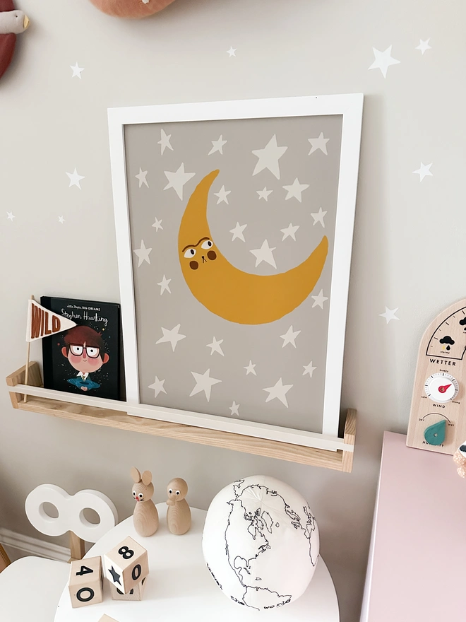 Moon Print shown on a shelf decorating a kids bedroom. 