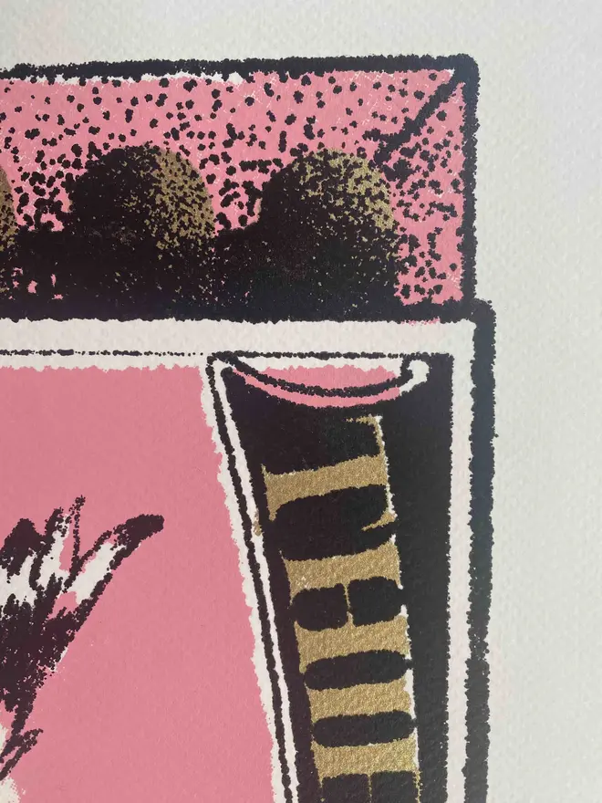 
A close-up photograph of a limited edition A2 screenprint. The print depicts a retro-style matchbox illustration in pink, black, and gold. A large, realistic seagull with a mischievous expression and an open beak is flying across the center. The words "THIEVING SEAGULL" are at the top, and "TRADE MARK" is on either side of the seagull. A banner at the bottom says "MADE IN FOLKESTONE." The background is a solid pink with a slight gold texture. The matches on the side are green and heart-shaped. Below the main image, the print is signed and numbered 3/13. The entire image has a grainy texture, like a vintage screen print.