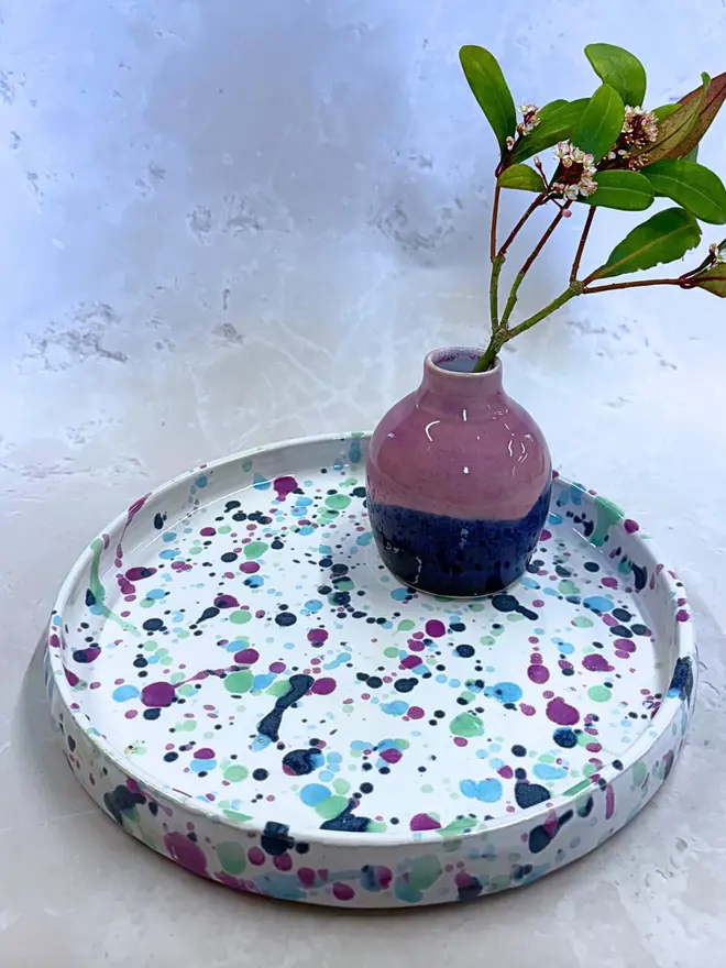 Sweetpea Tray, a colourful tray placed on a stone surface. It is accompanied by a plant. 