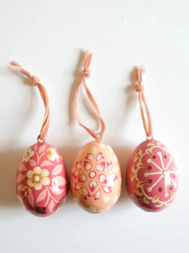 Group shot of hand painted decorative eggs with velvet string