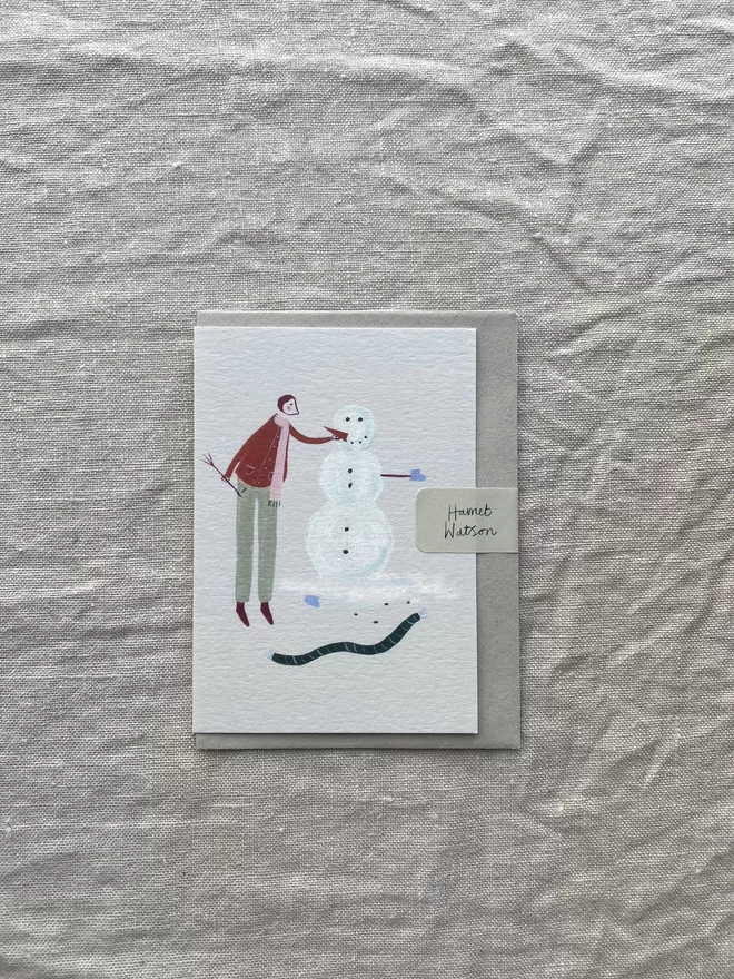 man and snowman on card 