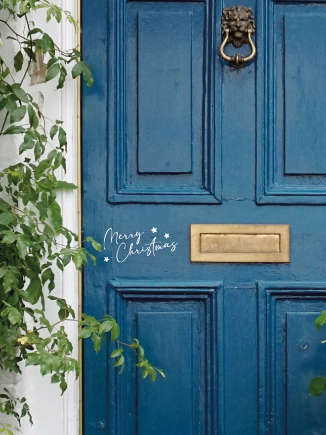merry christmas wall sticker on a blue front door