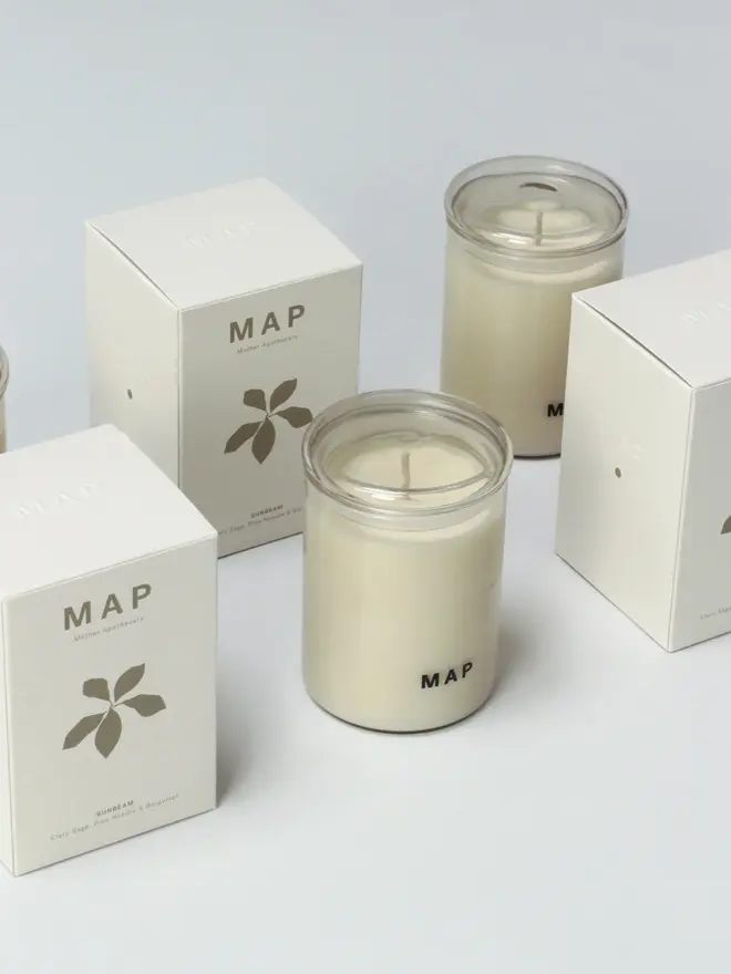 sunbeam clary sage and bergamot soy candle. candle pictured alongside plastic free box packaging.