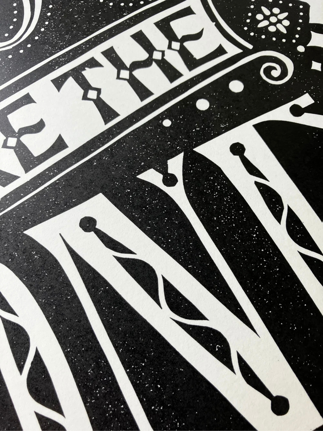 you are the one linocut. a linocut phrase printed on black paint.