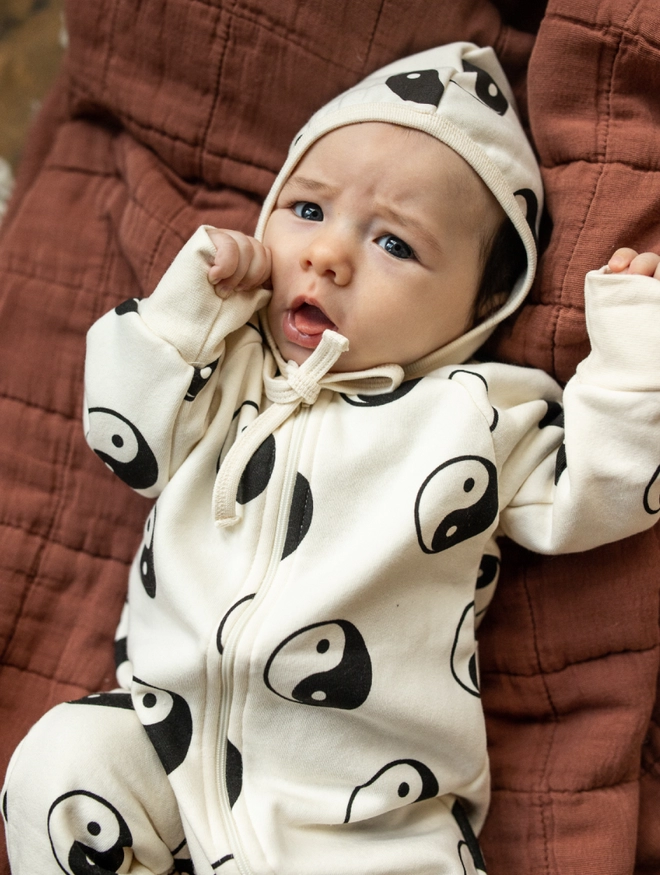 Another Fox Yin Yang Baby Sleepsuit seen on a baby with a yin and yang hood up.