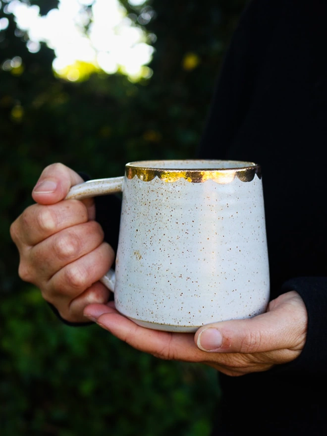 laura lane ceramics stoneware gold scalloped mug on dark background