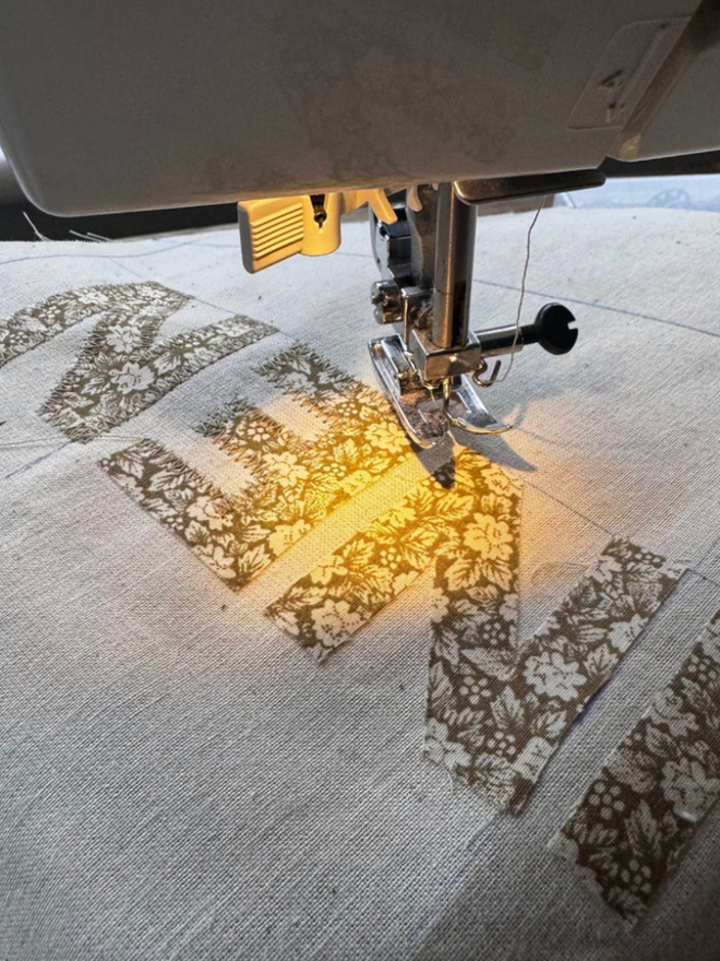 Patterned Letter Banner. A small banner being sewn.