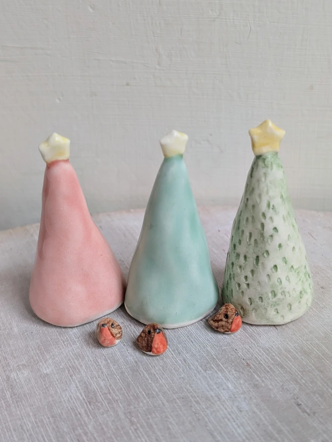 miniature robins and 3 ceramic christmas trees in green and pink