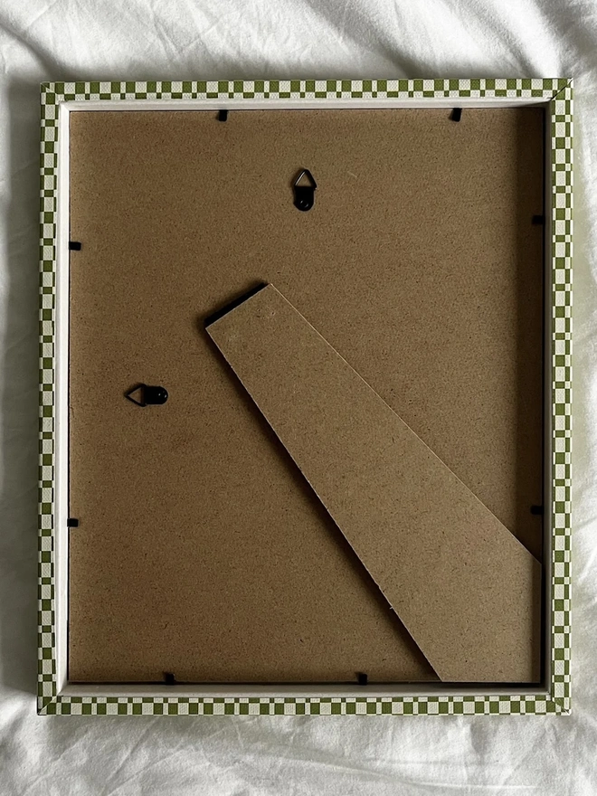 Green & Beige Checkered Frame, the back of a colourful frame sitting on a plain white surface. 