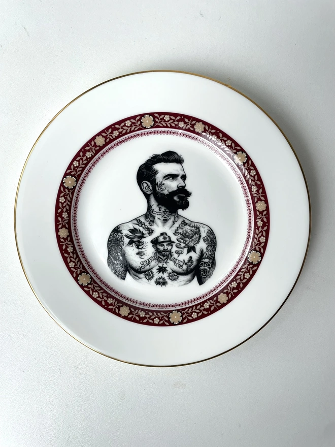 a vintage plate with ornate border, within the centre i have printed the vintage style image of a victorian tattooed sailor man