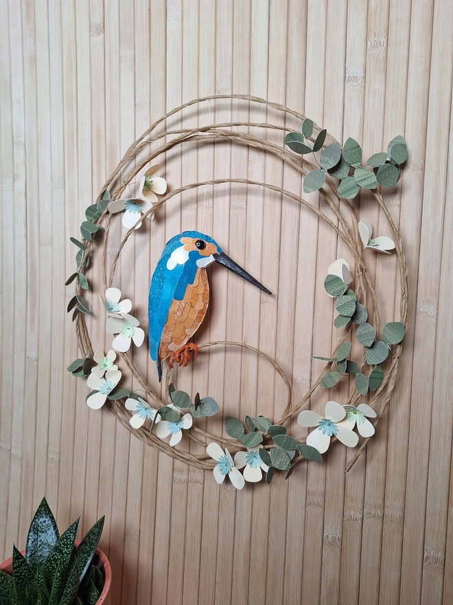 Handmade paper flower wreath featuring a kingfisher sculpture