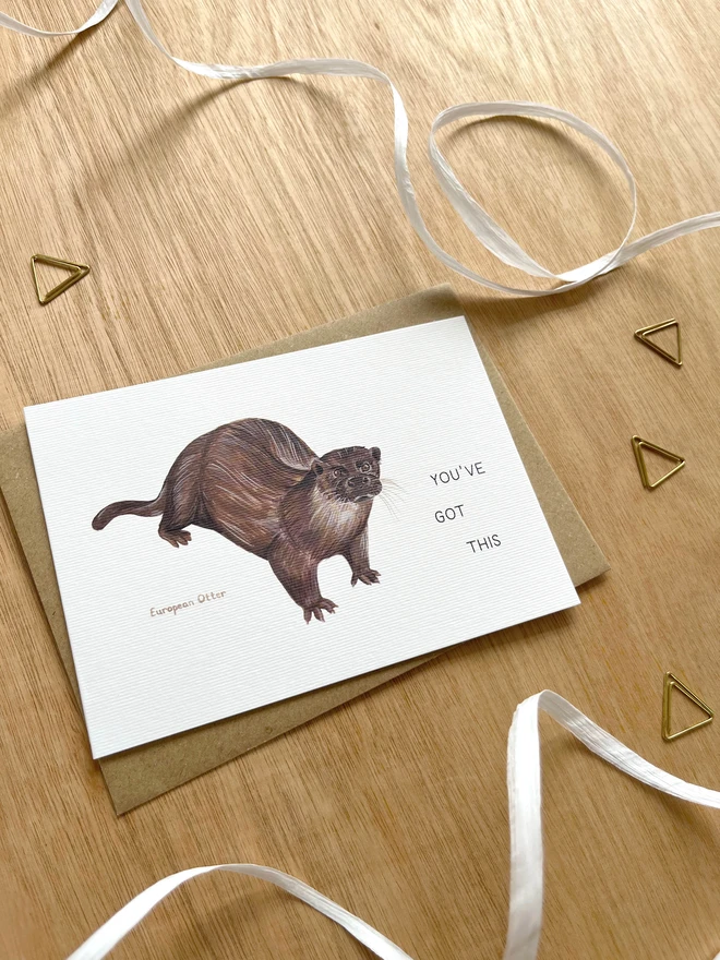 a greetings card featuring an illustration of an Otter with the text “You’ve Got This”