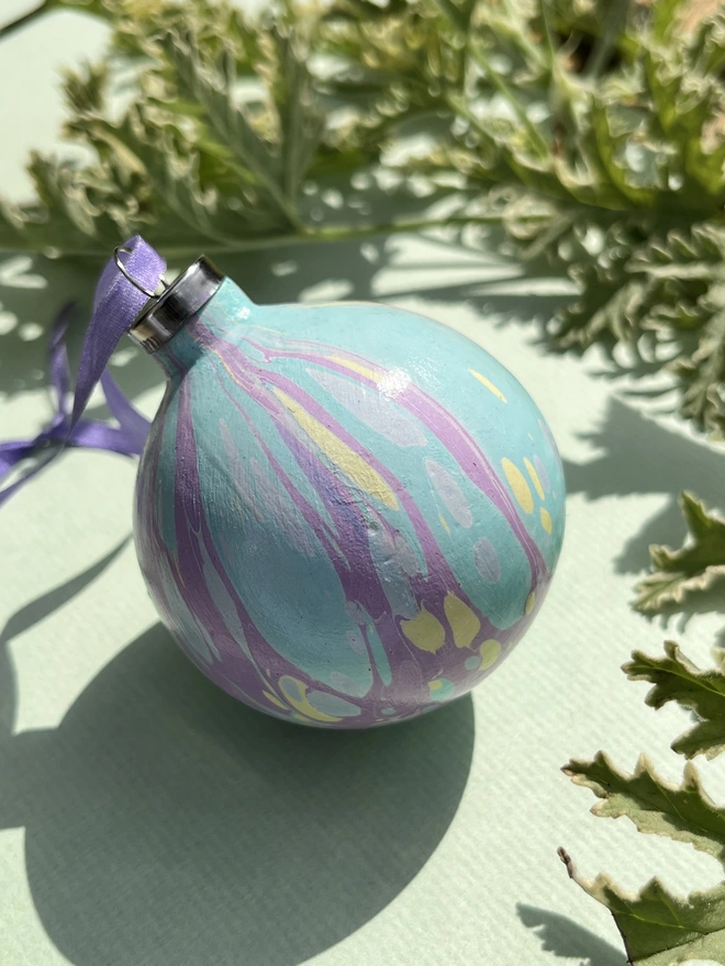 Hand-marbled round ceramic Christmas bauble