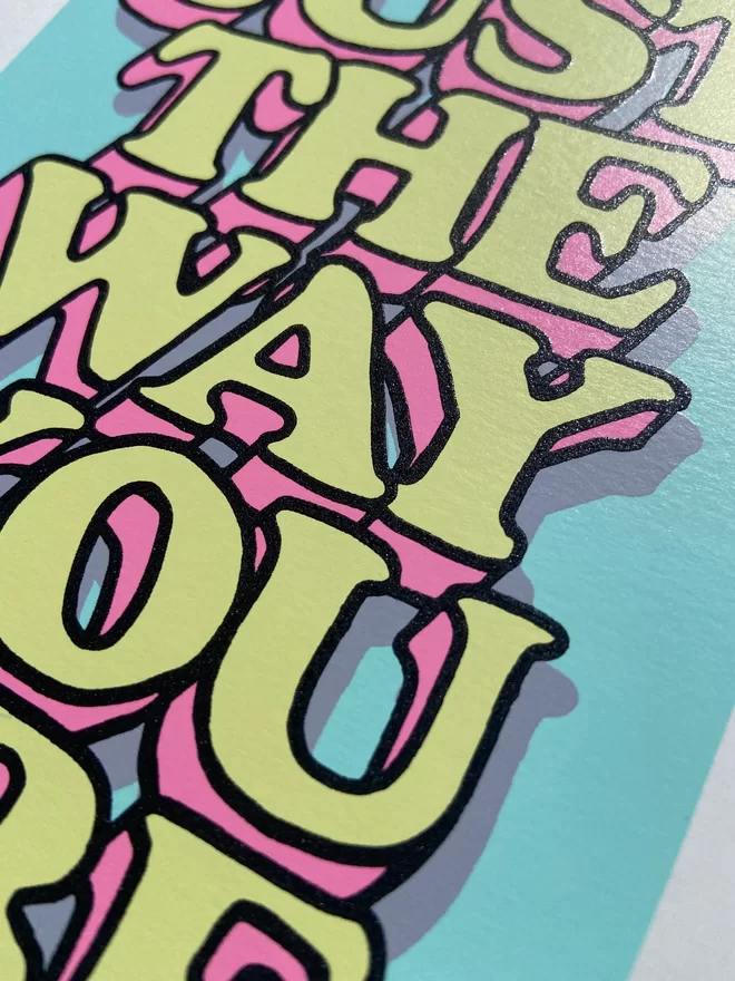 "Just The Way You Are” Mini A5 Hand Pulled Screen Print In pastel blue with the words just the way you are in hand drawn lettering printed on top with black outline and pink and yellow fill