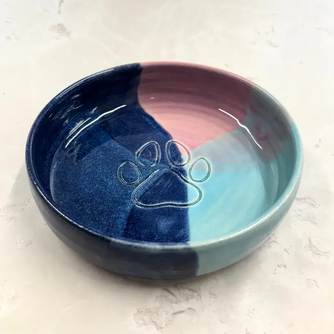 Landscape Dog Bowl, a colourful dog bowl sitting on a stone surface. 