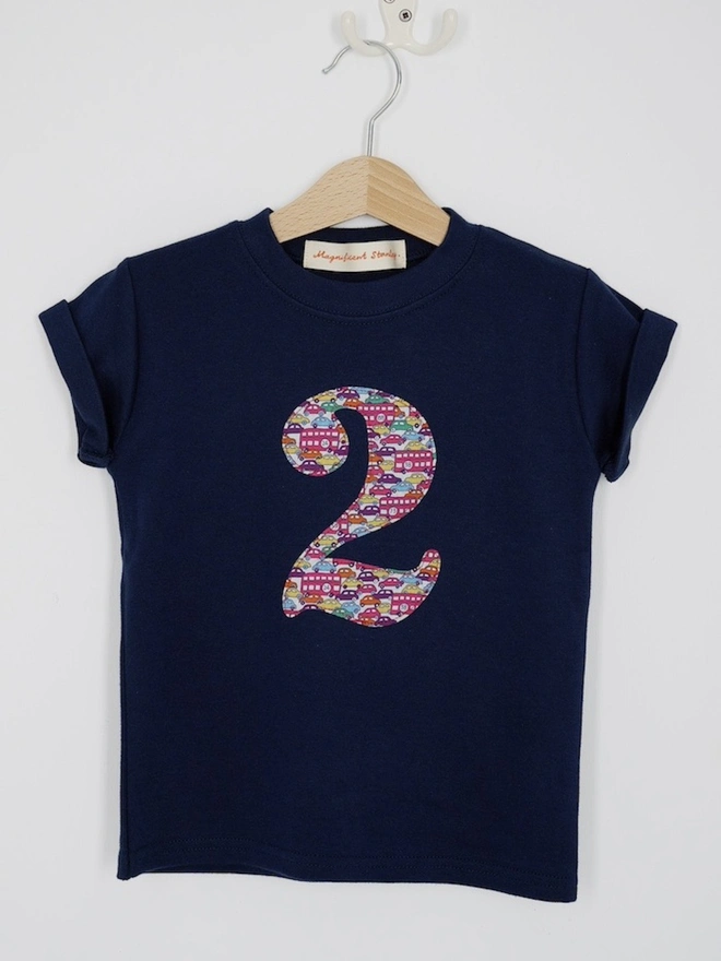 a navy birthday t-shirt with a number 2 cut from liberty london bus and car print on the front