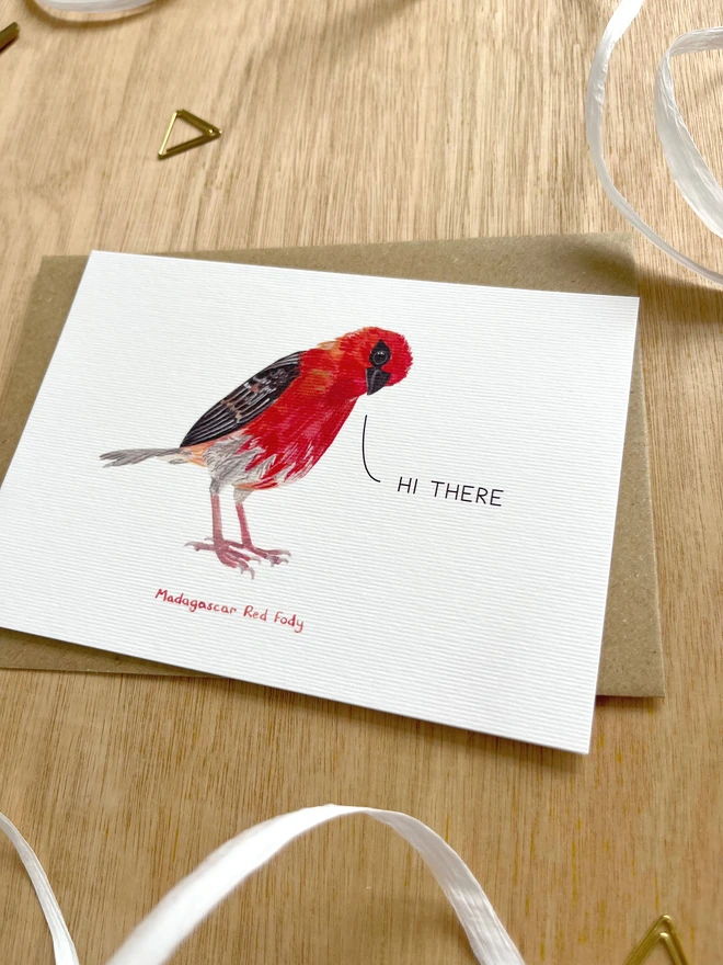  a greetings card featuring an illustration of a red fody with the text hi there”