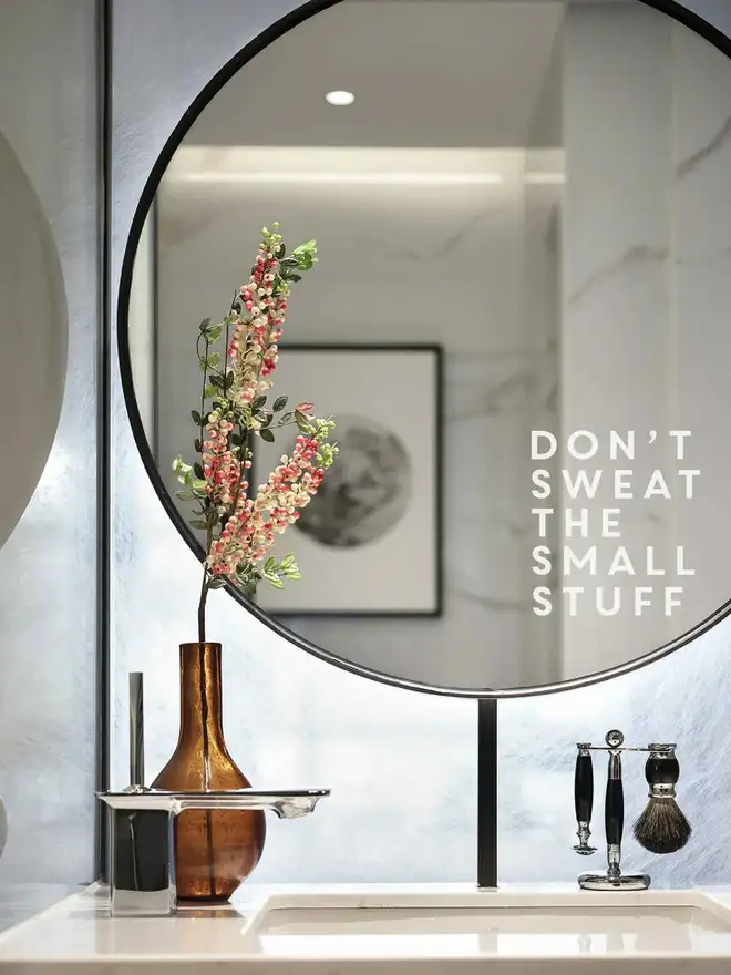 Vinyl decal reading “Don’t Sweat the Small Stuff” applied to a bathroom mirror as a gentle daily reminder.