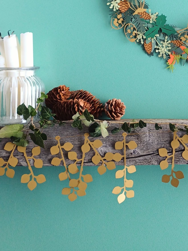 Gold Berry Paper Garland hung on Mantelpiece styled with candles, pinecones and Christmas wreath