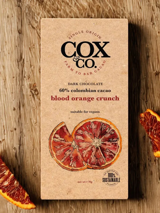 blood orange chocolate bar in brown packaging on a wooden table