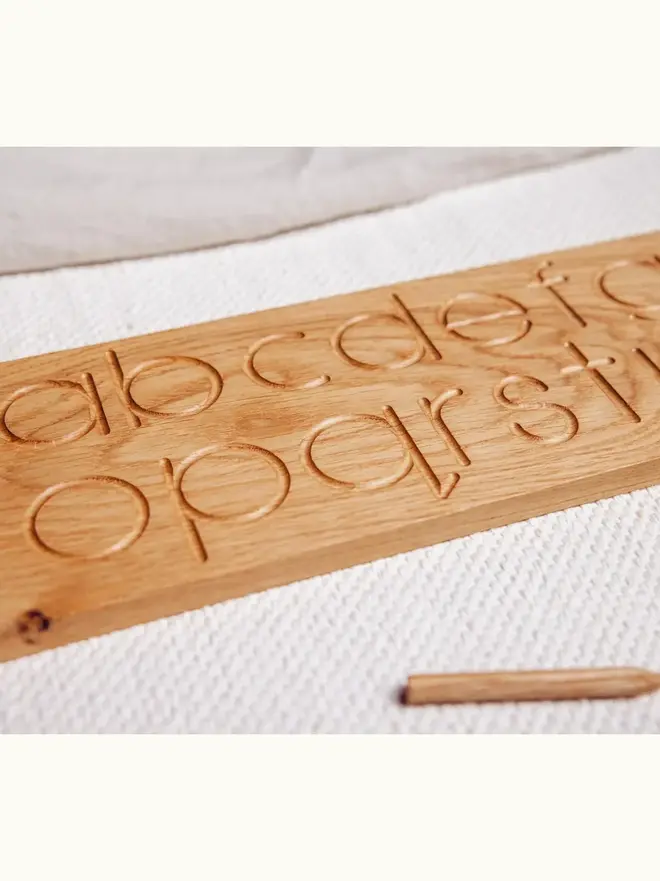 Wooden Alphabet Tracing Board Heirloom Toy, on a table. 