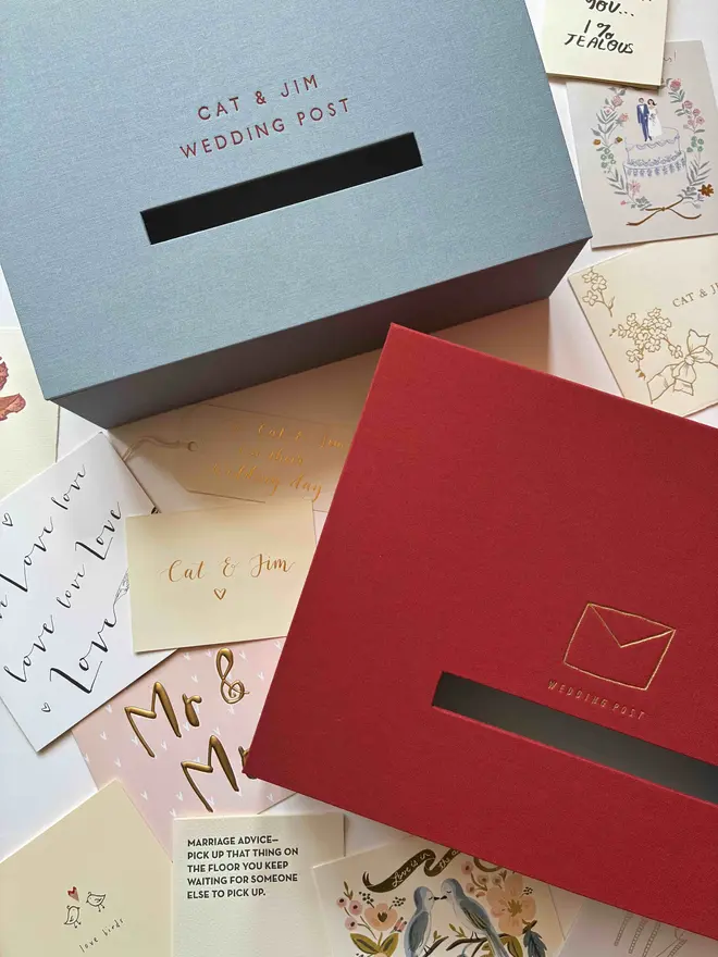 Two handmade wedding postboxes, one in Powder Blue book cloth and one in traditional post box red with foiled details