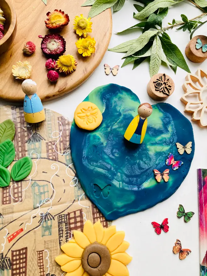 earth sensory play dough. a craft set up with earth blue and green play dough.