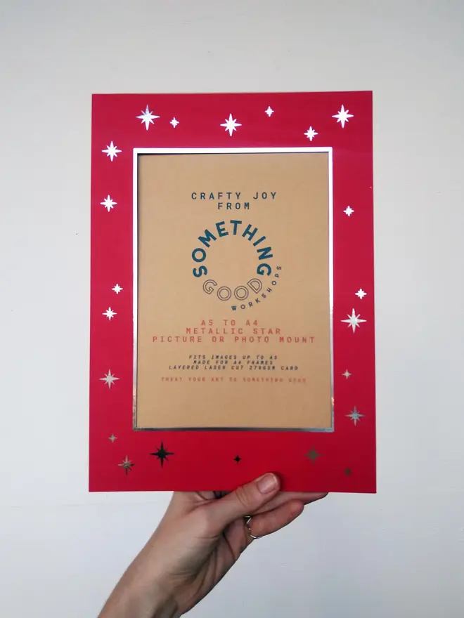 metallic star a5 / a4 christmas photo mount. red mount photographed against grey background.