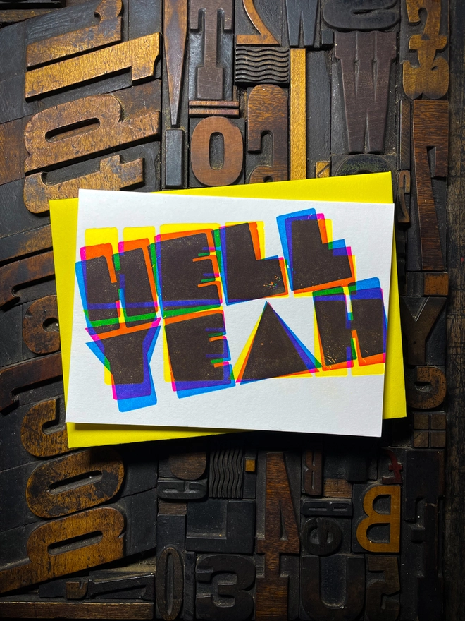 A congratulatory letterpress card using vibrant fluorescent inks the deep impression word HELL YEAH; in bold letters with a set of colourful envelopes. Perfect for exam results and graduations and other celebrations and milestones.