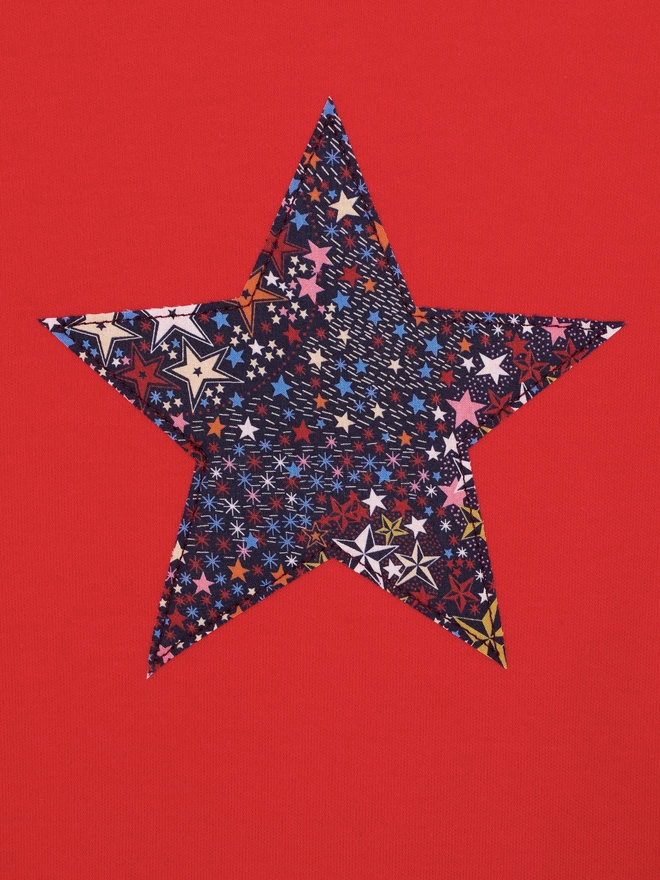 A red tee with a Liberty star print star sewn on the front