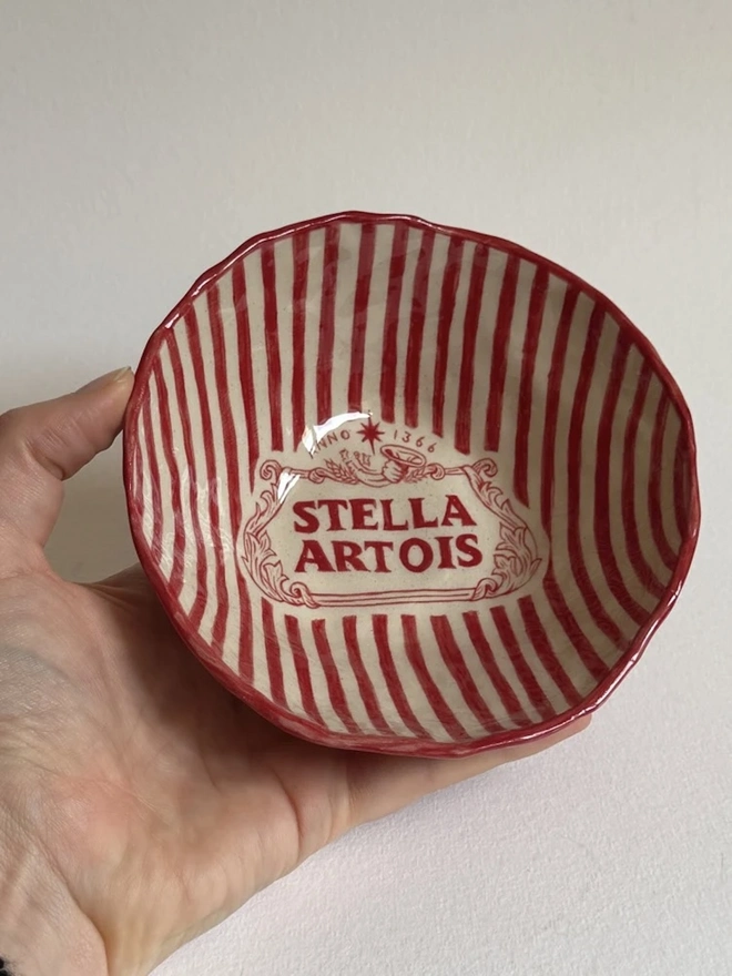 'Stella' Small Bowl, a small ceramic bowl held above a plain white surface. 