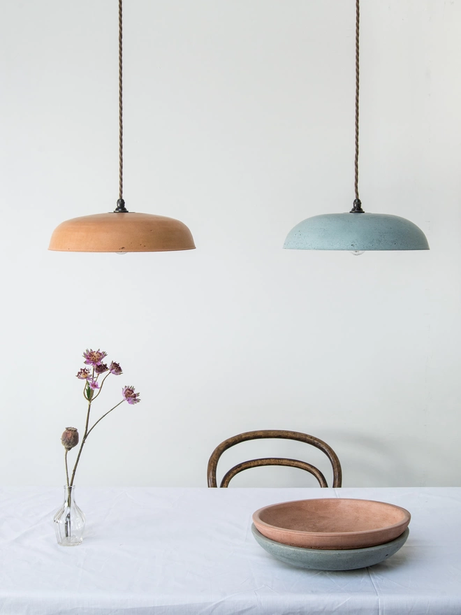 pair of dune pendant lampshades suspended above table and bowls