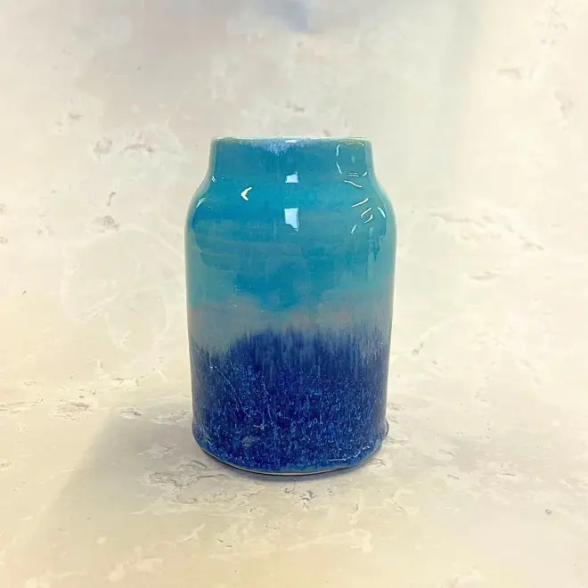 Landscape Medium Vase, a colourful vase sitting on a stone surface. 