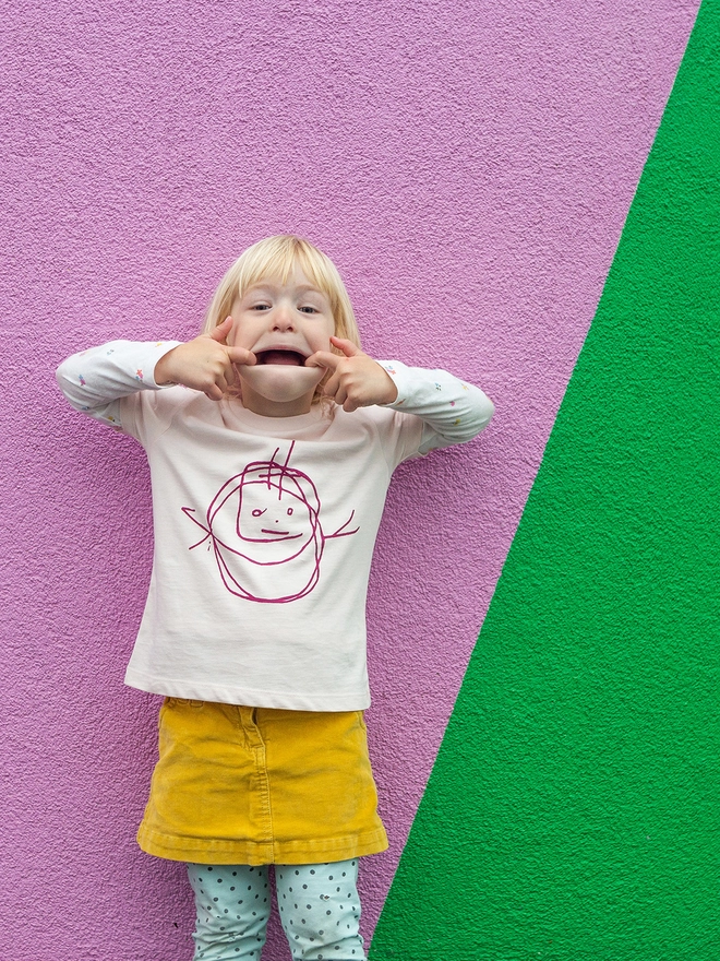 Child with her own drawing on her t-shirt