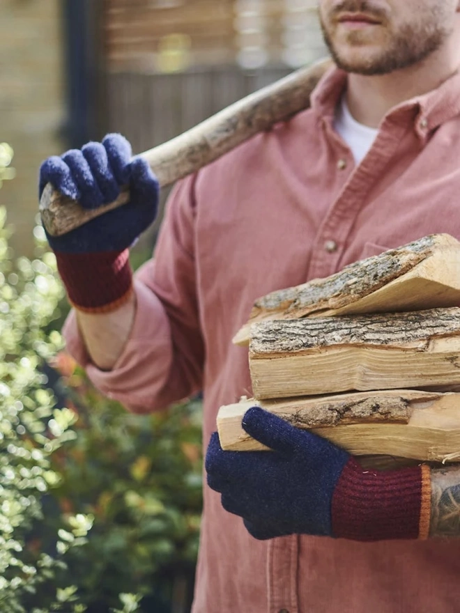 Block Lambswool Gloves, a pair of colourful gloves worn by a man having just chopped wood. 