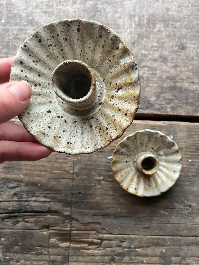 Handmade Natural Speckled Ceramic Candlestick Holder, a pair of ceramic candlestick holders sitting on a wooden surface. 