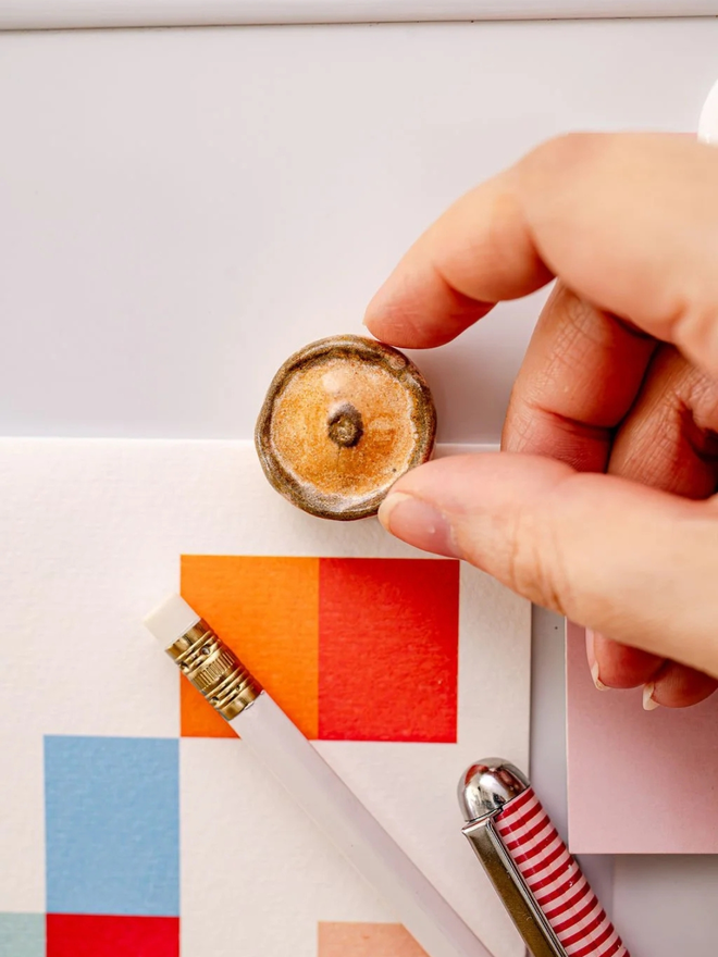 ceramic pastry magnets. a ceramic scotch pie magnet on a fridge door.