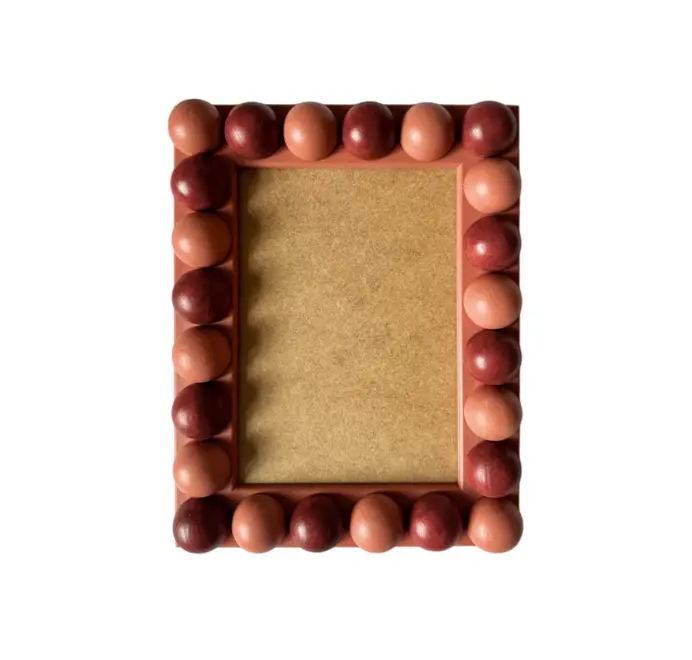 red and terracotta wood bobbin frame