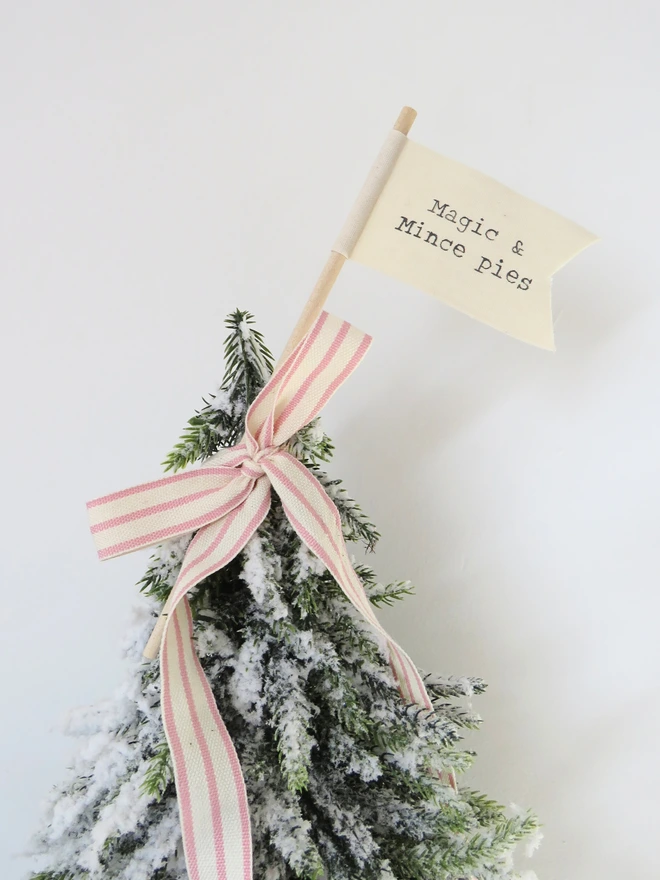 Organic cotton flag hand painted with festive message wrapped around wooden dowel