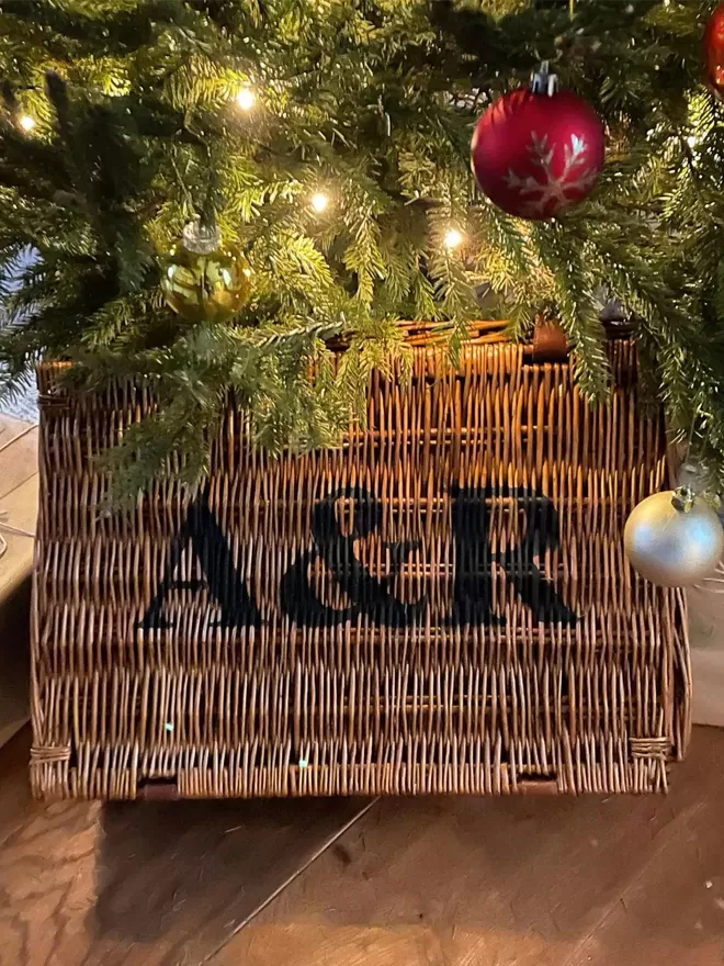 A personalised Christmas wicker hamper under the tree