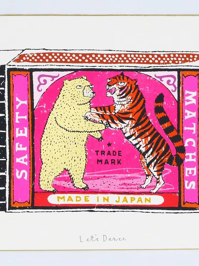 Bear And Tiger Matchbox Let's Dance, a colourful matchbox design on a white screenprint. It sits against a baby blue backdrop. 