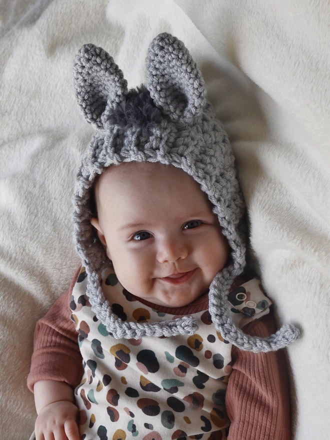Baby wearing a bonnet with donkey ears