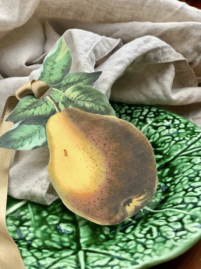 Close up of a handcut, printed fabric, botanical pear table decoration