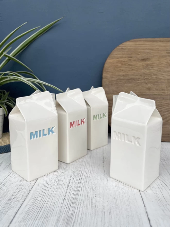 4 handmade milk cartons shows the different colours the lettering can be - blue, red, green or plain.
