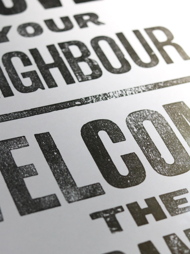 Original letterpress poster featuring the words 'Love your neighbour, welcome the stranger'