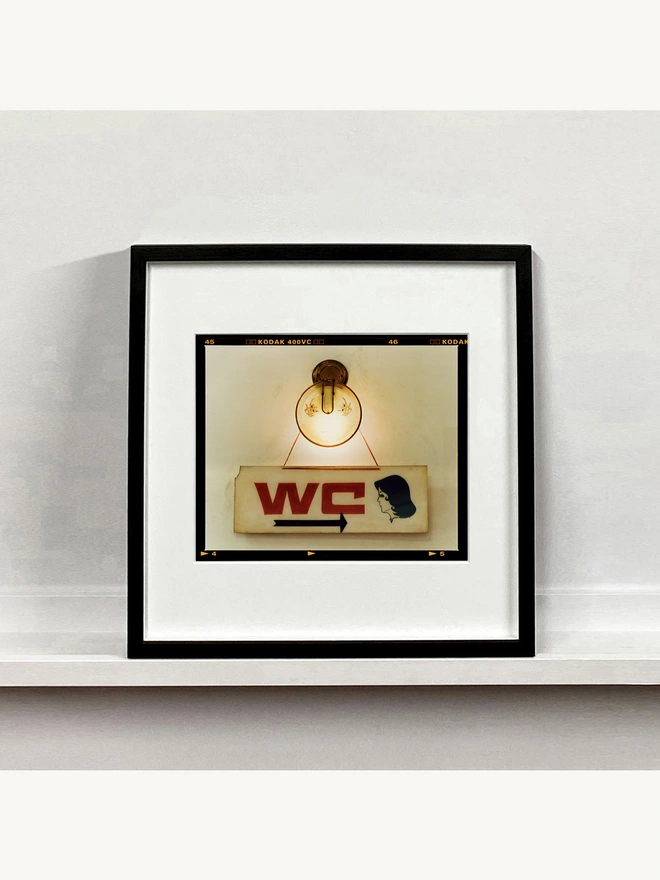 WC sign photograph mounted square framed in black