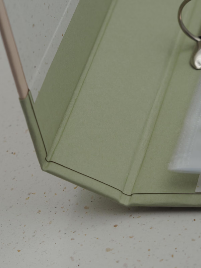 personalised keepsake ring binder. a personalised green ring binder photographed open to show joining.